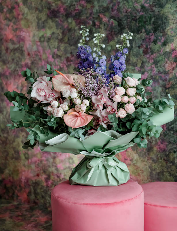 Mixed shades of pink& purple blooms in vase 