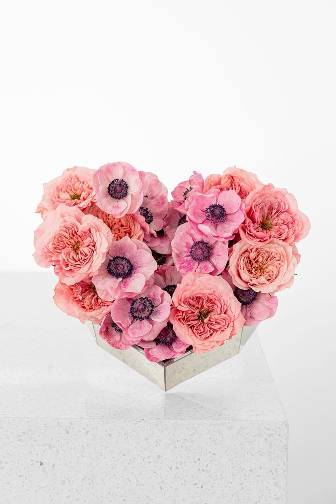 Mix of pinks roses with pink anemone in a mini heart shaped box