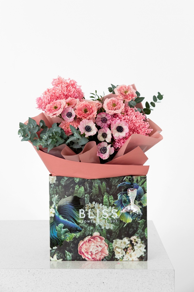 Mix of pink flowers with anemone, roses and hydragenia.