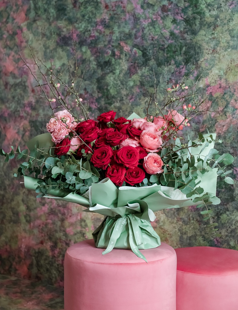 Red, pink and spray pink roses with eucalyptus
