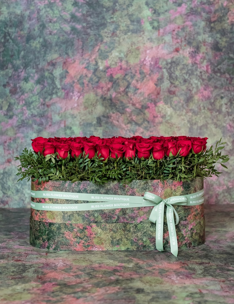 red roses in oval box